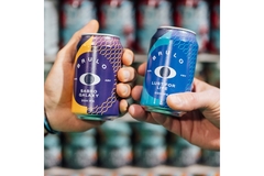 Image Two hands holding Brulo beer cans.